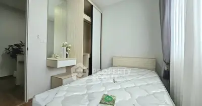 Cozy bedroom with modern design and ample natural light, featuring a built-in wardrobe and stylish decor.