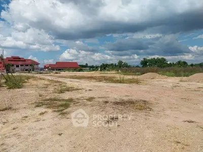 Expansive land plot with potential for development under a clear blue sky.