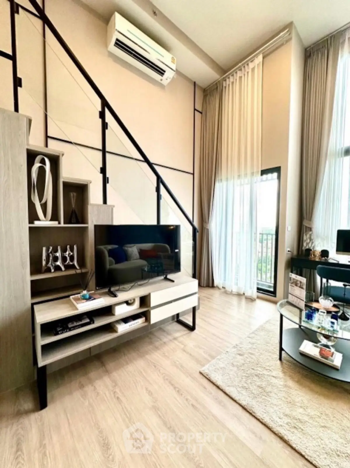 Modern loft-style living room with high ceilings and stylish decor