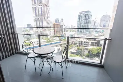 Stunning city view from a modern balcony with elegant seating, perfect for relaxation and enjoying urban skyline.