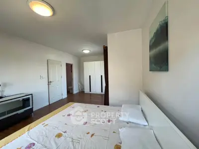 Spacious bedroom with modern decor and ample natural light