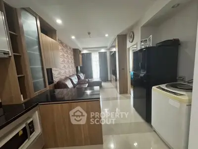 Modern open-plan living room with sleek kitchen and stylish decor