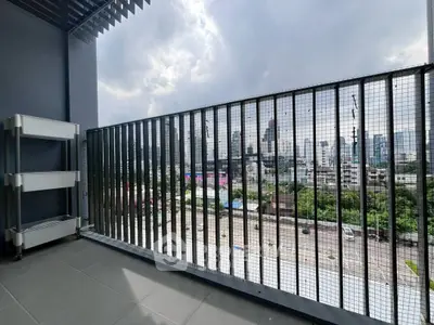 Spacious balcony with city skyline view, perfect for urban living.