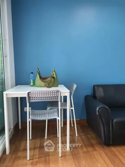 Modern living room with blue accent wall and minimalist furniture