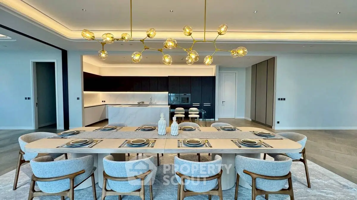 Luxurious dining area with modern lighting and elegant table setting in open-plan kitchen.
