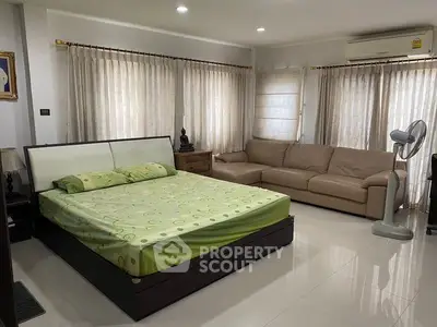 Spacious bedroom with modern furnishings and ample natural light