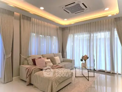 Luxurious living room with elegant curtains and cozy seating area, perfect for relaxation and entertaining.