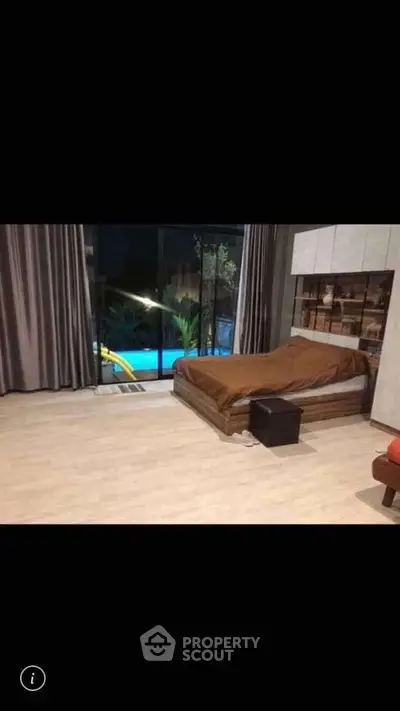 Spacious bedroom with pool view and modern decor