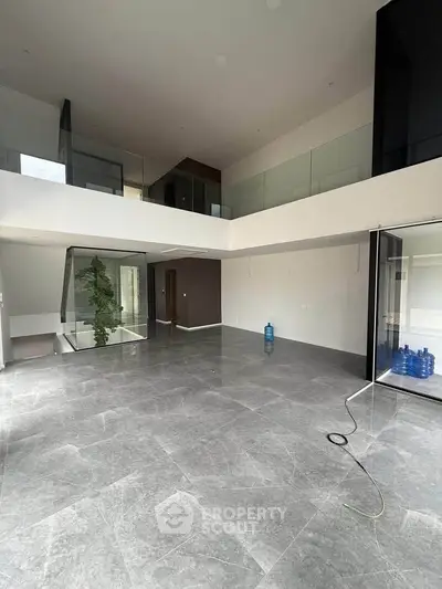 Spacious modern living room with high ceilings and elegant marble flooring