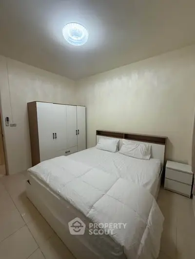 Cozy bedroom with modern furniture and soft lighting, perfect for relaxation.