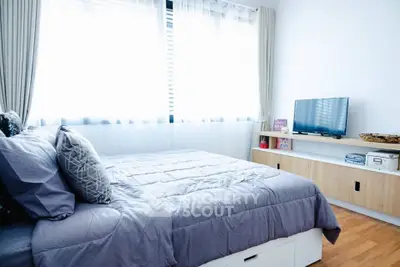 Bright modern bedroom with cozy bedding and natural light