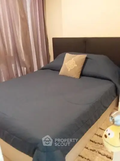 Cozy bedroom with stylish decor and comfortable bedding in modern apartment.