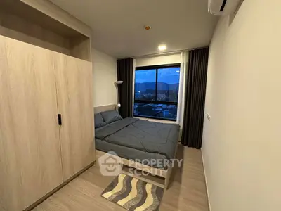 Modern bedroom with mountain view, featuring sleek wooden wardrobe and cozy bedding.