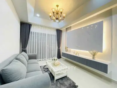 Elegant living room with chandelier, modern sofa, and stylish decor