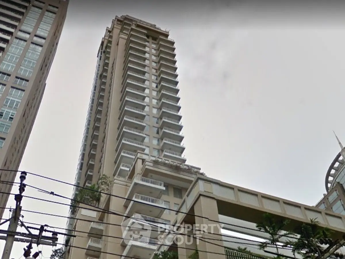 Stunning high-rise building with modern architecture and spacious balconies in urban setting.