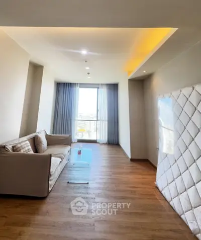 Spacious living room with modern decor and large window view