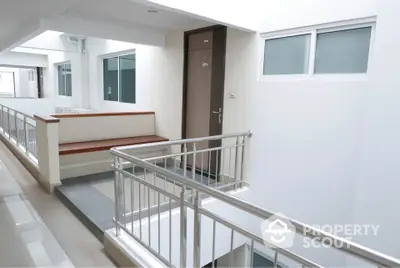 Modern apartment corridor with sleek design and natural lighting