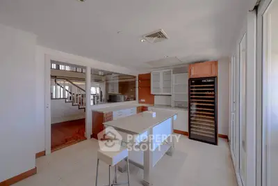 Spacious modern kitchen with island and wine cooler in luxury home
