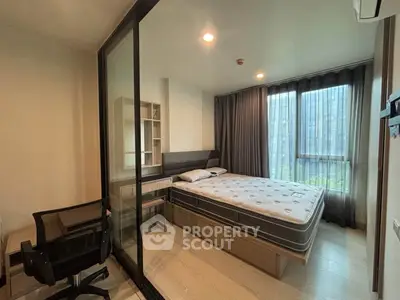 Modern bedroom with large window and glass partition, featuring a comfortable bed and study area.