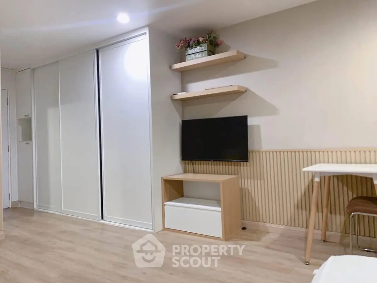 Modern living room with sleek storage and mounted TV, perfect for urban living.