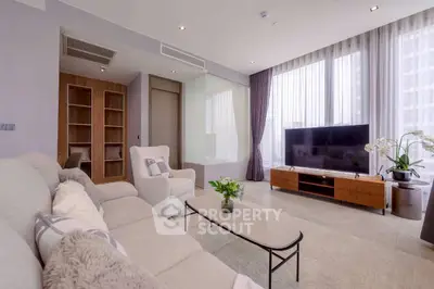Spacious modern living room with large windows and elegant decor