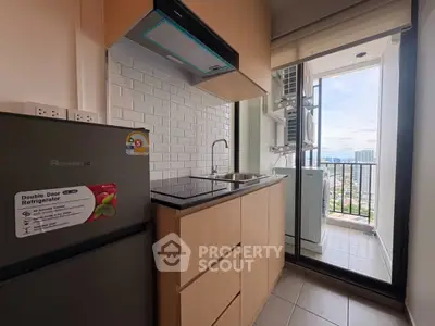 Modern kitchen with balcony view in high-rise apartment
