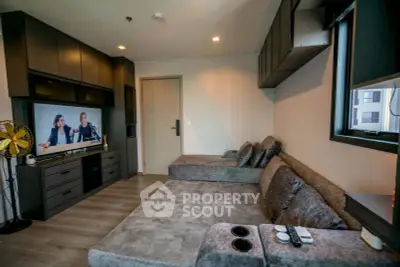 Modern living room with stylish furniture and entertainment center in a cozy apartment.