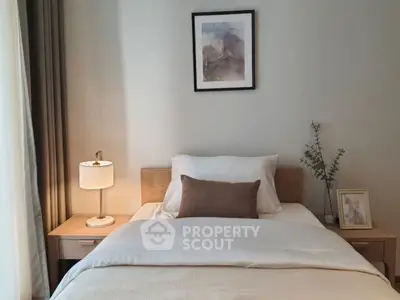 Cozy bedroom with modern decor, featuring a comfortable bed and elegant lighting.