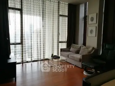 Elegant living room with floor-to-ceiling windows and modern furnishings.