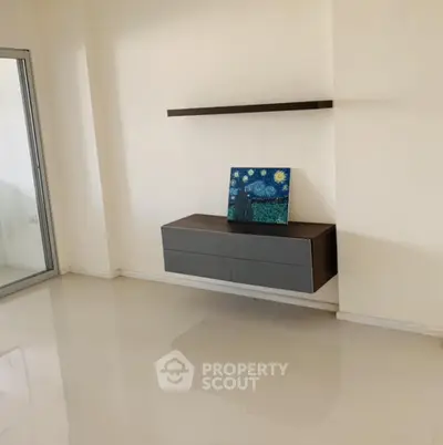 Minimalist living room with sleek floating shelf and modern art piece