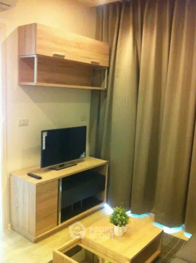 Cozy living room with modern wooden furniture and TV setup