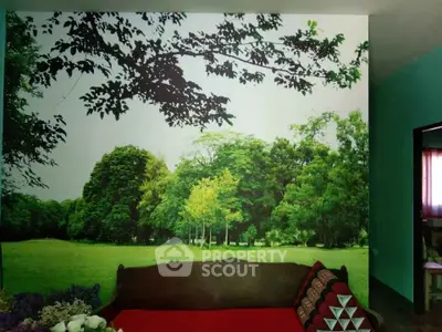 Charming bedroom with nature-themed wall mural and cozy decor