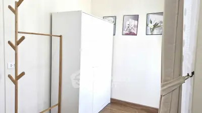 Cozy bedroom corner with white wardrobe and elegant decor