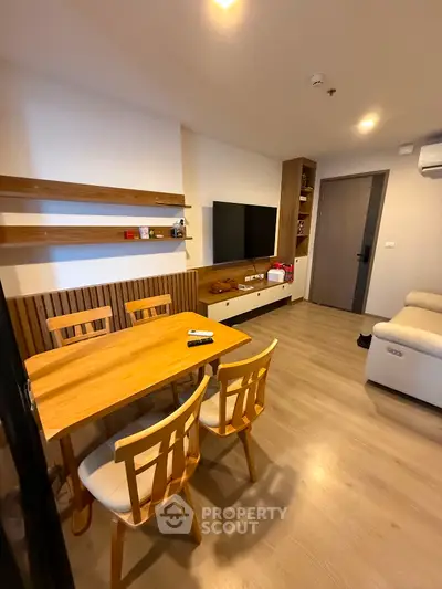Modern living room with wooden furniture and wall-mounted TV