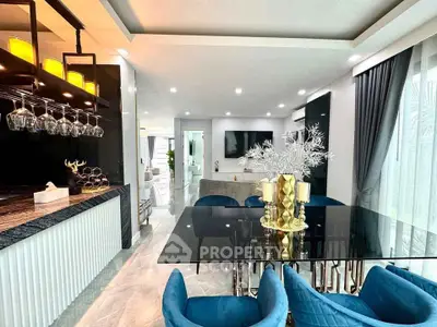 Luxurious open-plan living and dining area with modern decor and elegant lighting.