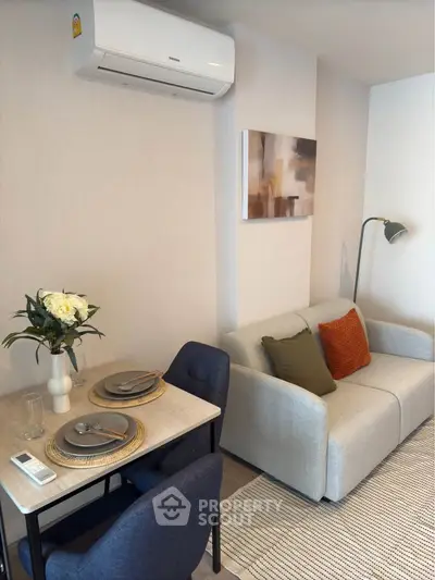 Modern living room with cozy sofa and dining area, perfect for urban living.