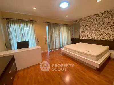 Spacious bedroom with modern decor and natural light