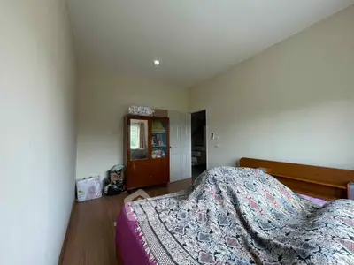 Cozy bedroom with wooden furniture and patterned bedding, perfect for relaxation.