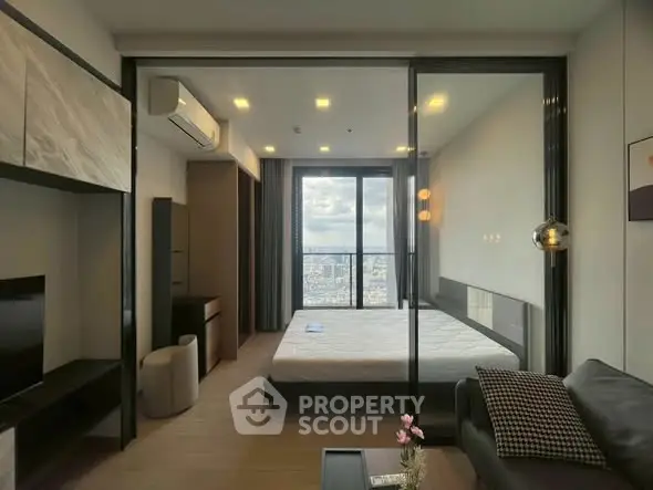 Modern bedroom with city view, featuring sleek design and ample natural light.