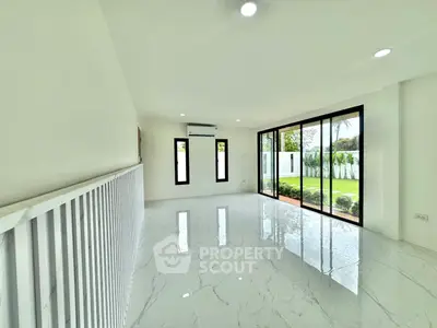 Spacious modern living room with large windows and garden view