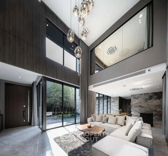 Luxurious modern living room with high ceilings and large windows
