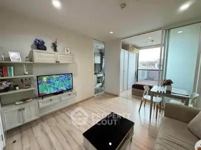 Modern living room with stylish decor and balcony access in a contemporary apartment.