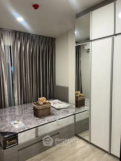 Modern bedroom with sleek wardrobe and cozy bed in stylish apartment