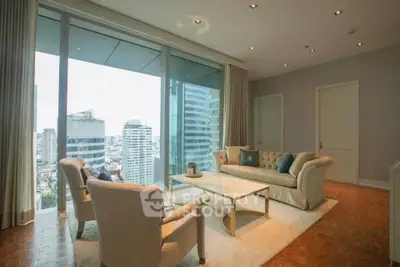 Luxurious high-rise living room with stunning city view and elegant furnishings.