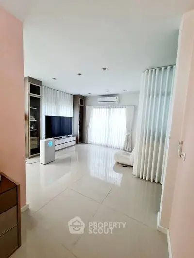 Spacious modern living room with sleek design and large windows for natural light.