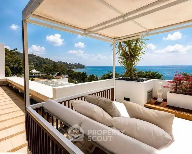 Luxurious rooftop terrace with stunning ocean view and elegant seating area.