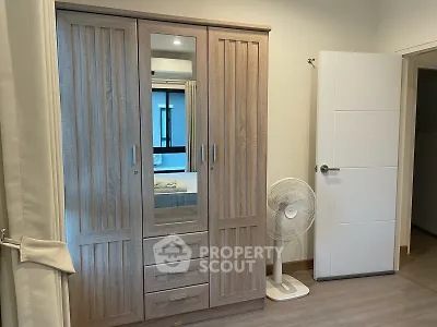Spacious bedroom with wooden wardrobe and modern decor