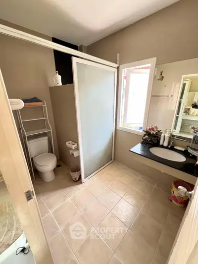 Spacious bathroom with modern shower and elegant sink area