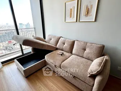 Modern living room with stylish sofa and city view balcony, perfect for urban living.