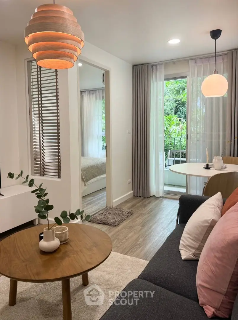 Chic modern living room with cozy decor and garden view, perfect for relaxation and entertaining.